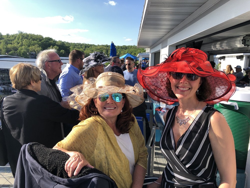 Friends wearing festive hats for a Derby celebration at Boathouse